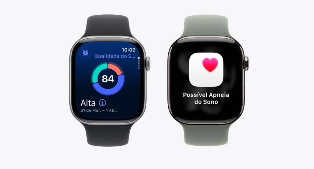 Dois Apple Watches lado a lado contra um fundo branco, exibindo métricas de monitoramento de saúde no pulso. O relógio da esquerda, com pulseira preta, mostra uma tela de sono com uma pontuação de 84, classificada como Qualidade do Sono Alta. O relógio da direita, com pulseira verde, exibe uma notificação de saúde com um ícone de coração vermelho e o texto em português 'Possível Apneia do Sono'.