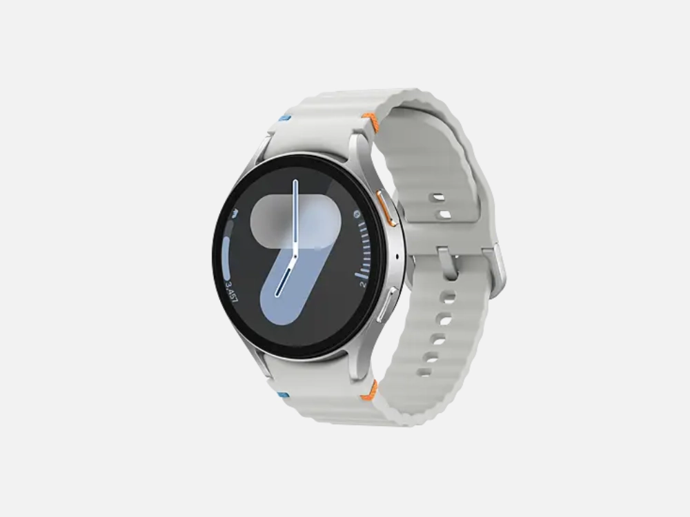 Smartwatch Samsung Galaxy Watch 7 na cor prata com pulseira branca texturizada e mostrador digital moderno. Uma excelente alternativa para quem busca os melhores smartwatches baratos.